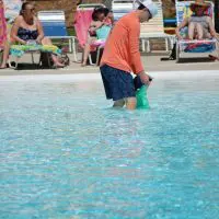 man and baby at pool